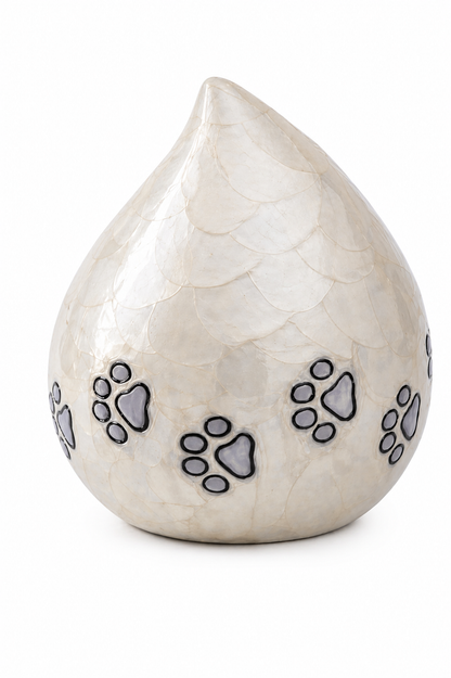Ivory Paws teardrop pet urn displayed on a table