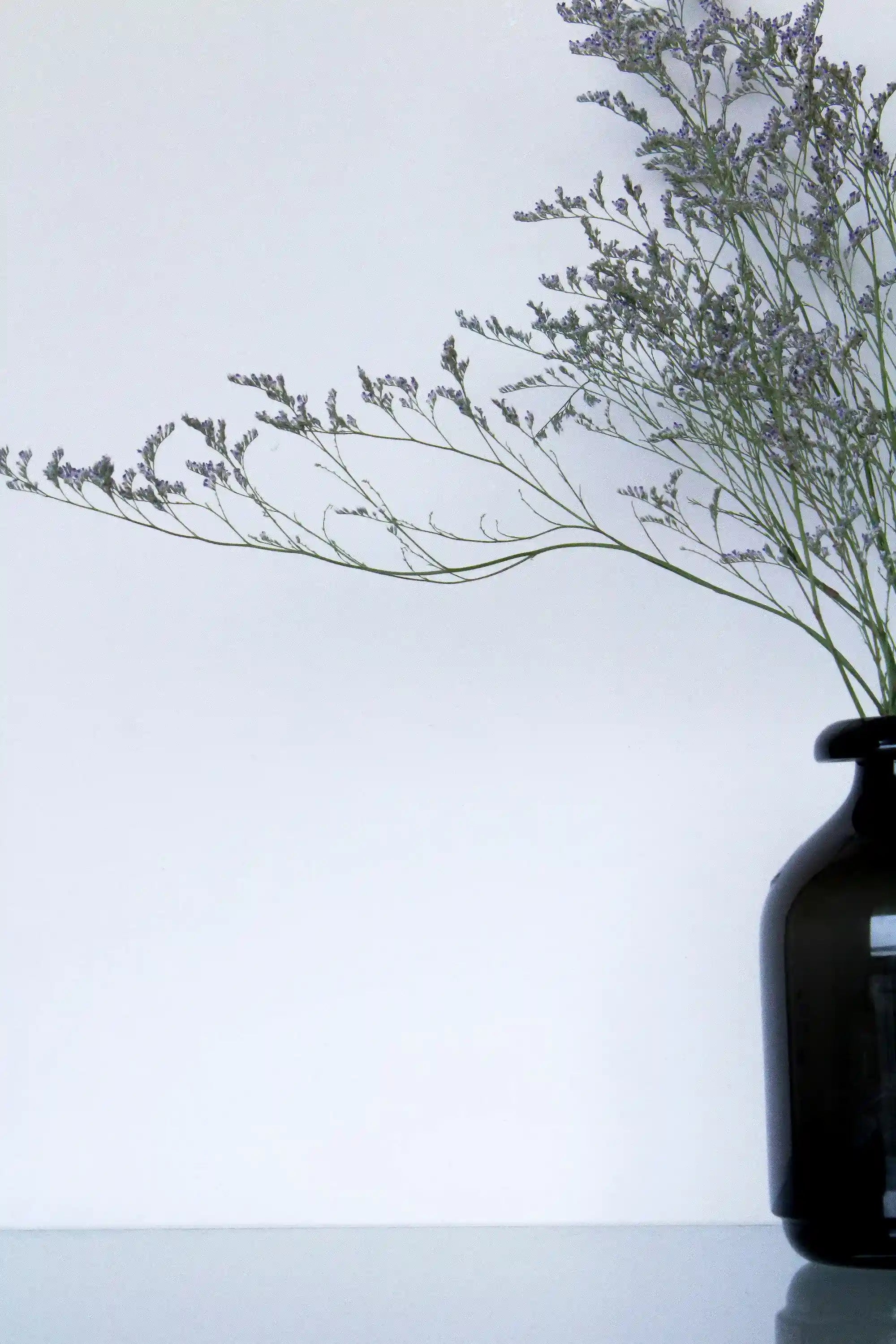 Glass vase-style cremation urn displayed as a memorial centerpiece